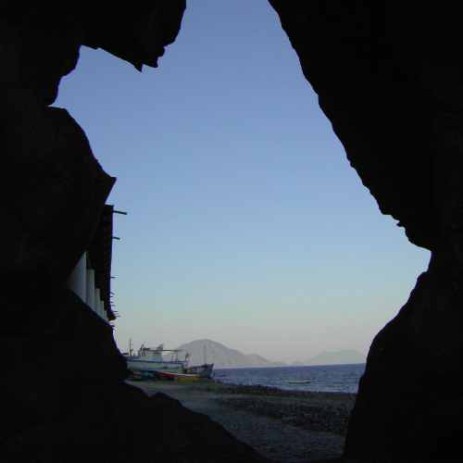 A view of Filicudi through Perciato, a facture in the mountain on the beach of Alicudi